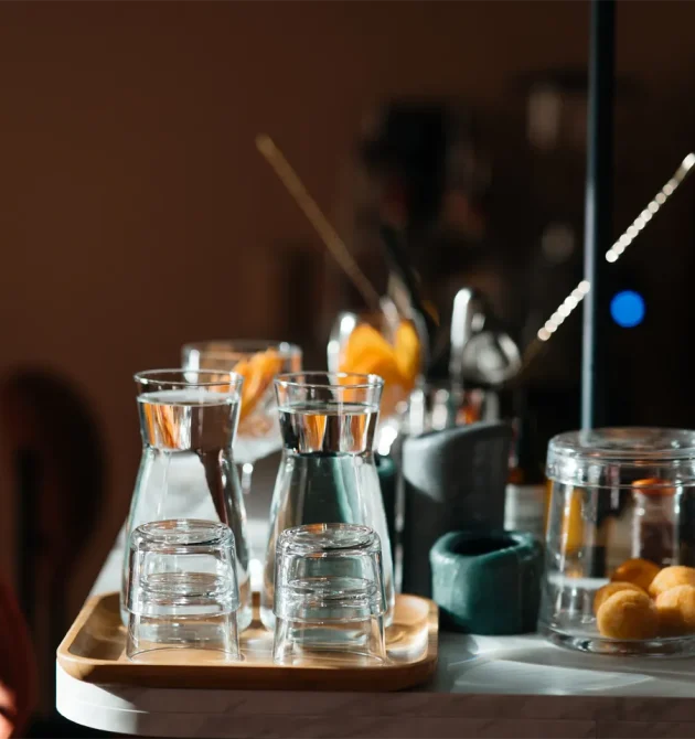 four-glass-cups-on-the-bar-counter-with-serving-ac-XMZ8WLJ